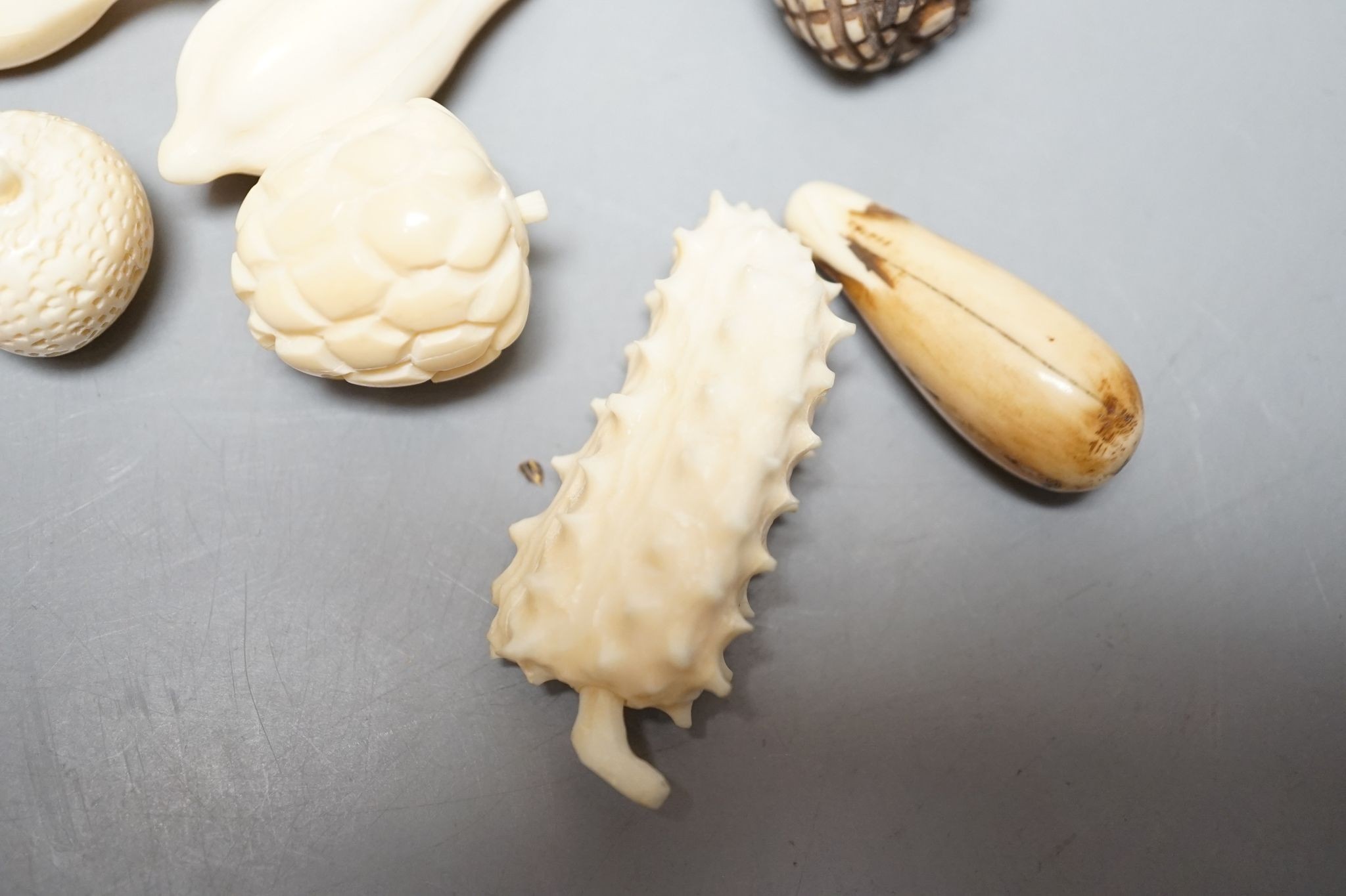A group of Chinese carved ivory fruits, on ‘leaf’, 19cm
